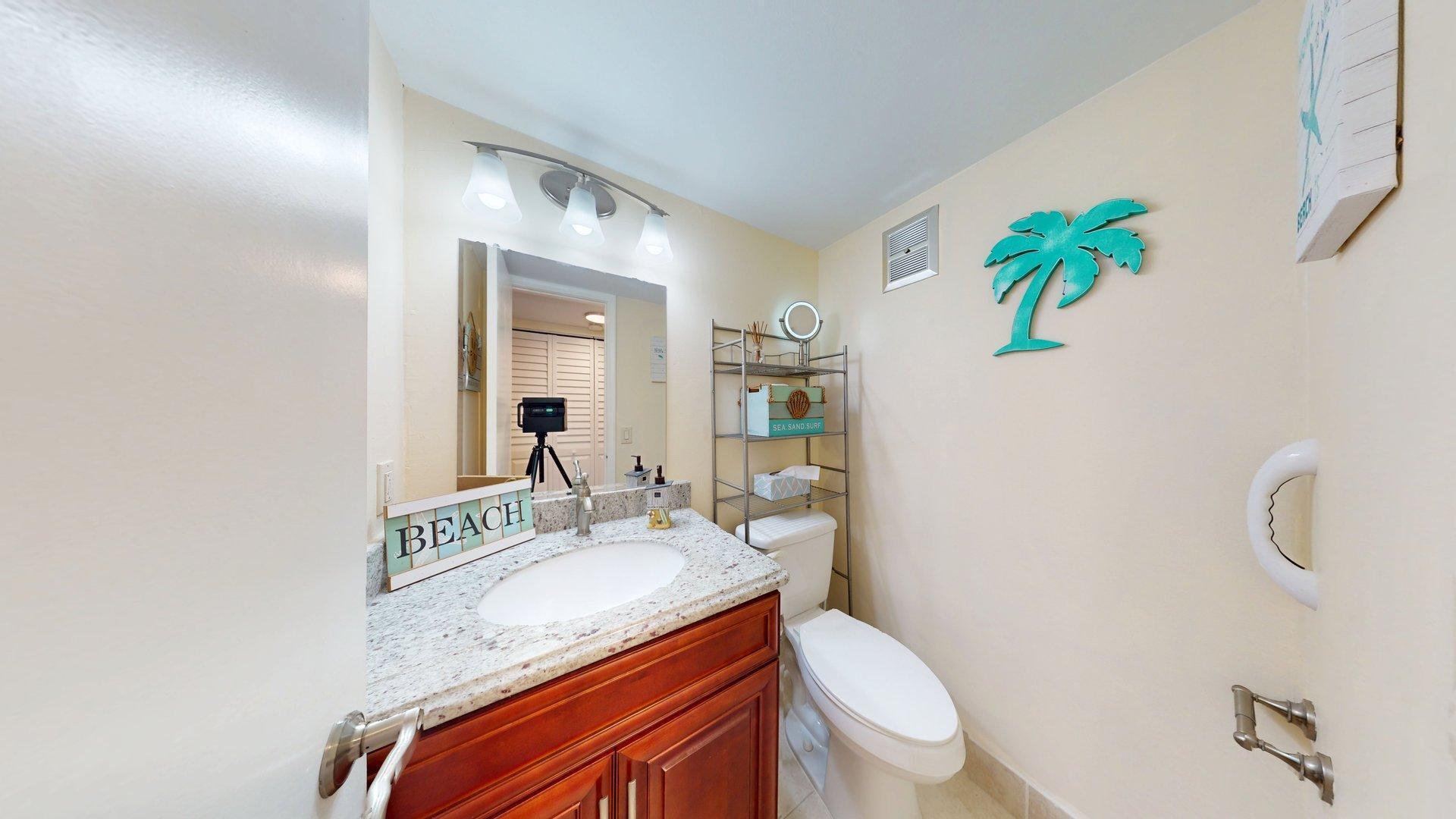 130 Dorchester East, Unit F West Palm Beach, FL 33417 - Photo 12 of 28 a bathroom with a granite countertop sink and a mirror