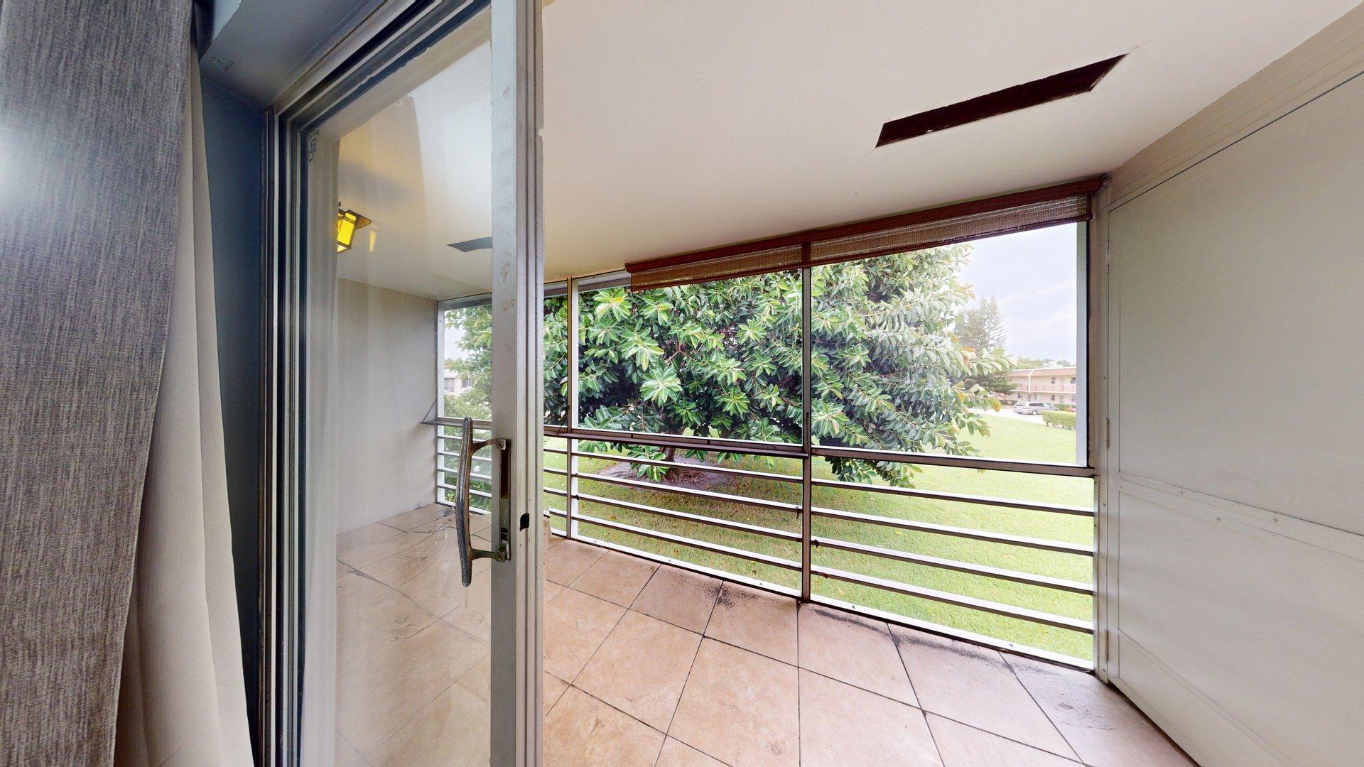 130 Dorchester East, Unit F West Palm Beach, FL 33417 - Photo 15 of 28 a view of a room with a large window