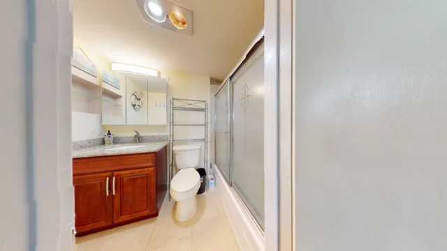 a bathroom with a sink a toilet and mirror