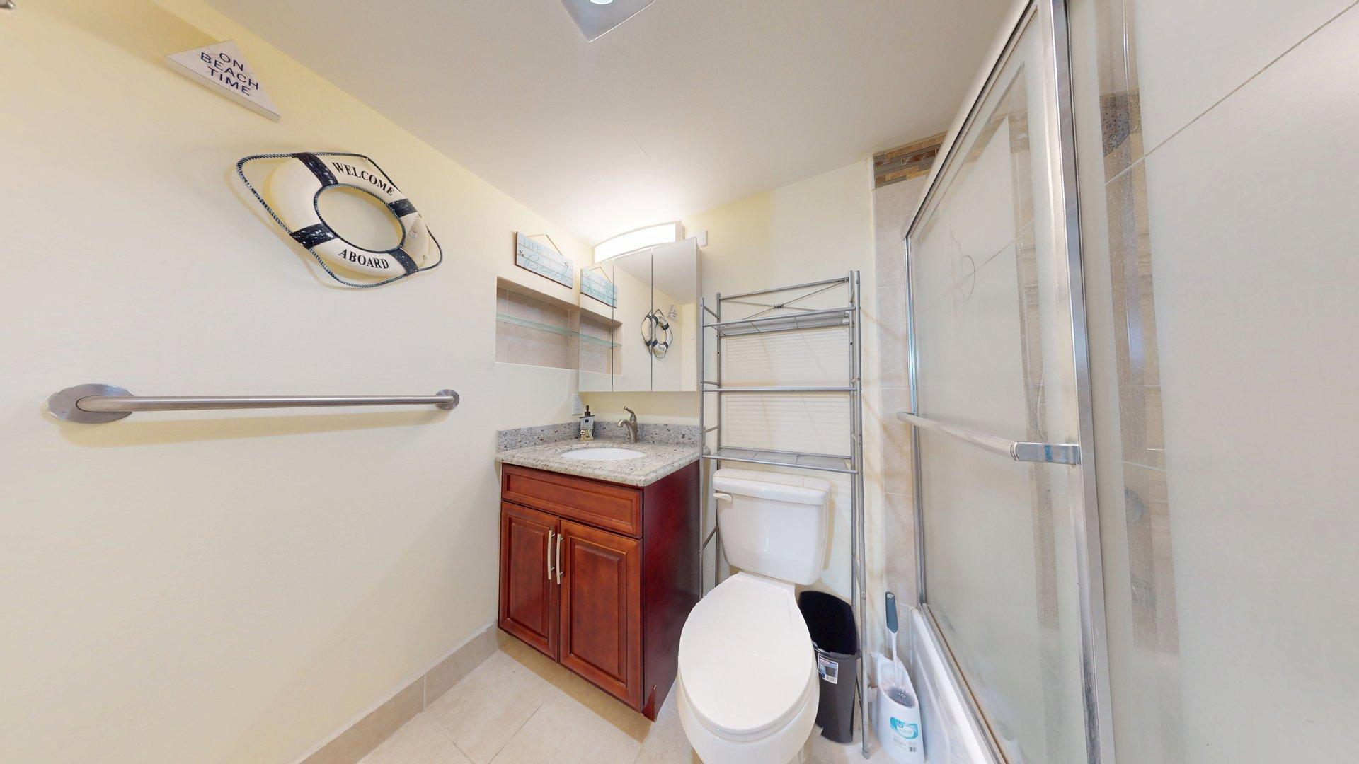 130 Dorchester East, Unit F West Palm Beach, FL 33417 - Photo 18 of 28 a bathroom with a sink a toilet and shower