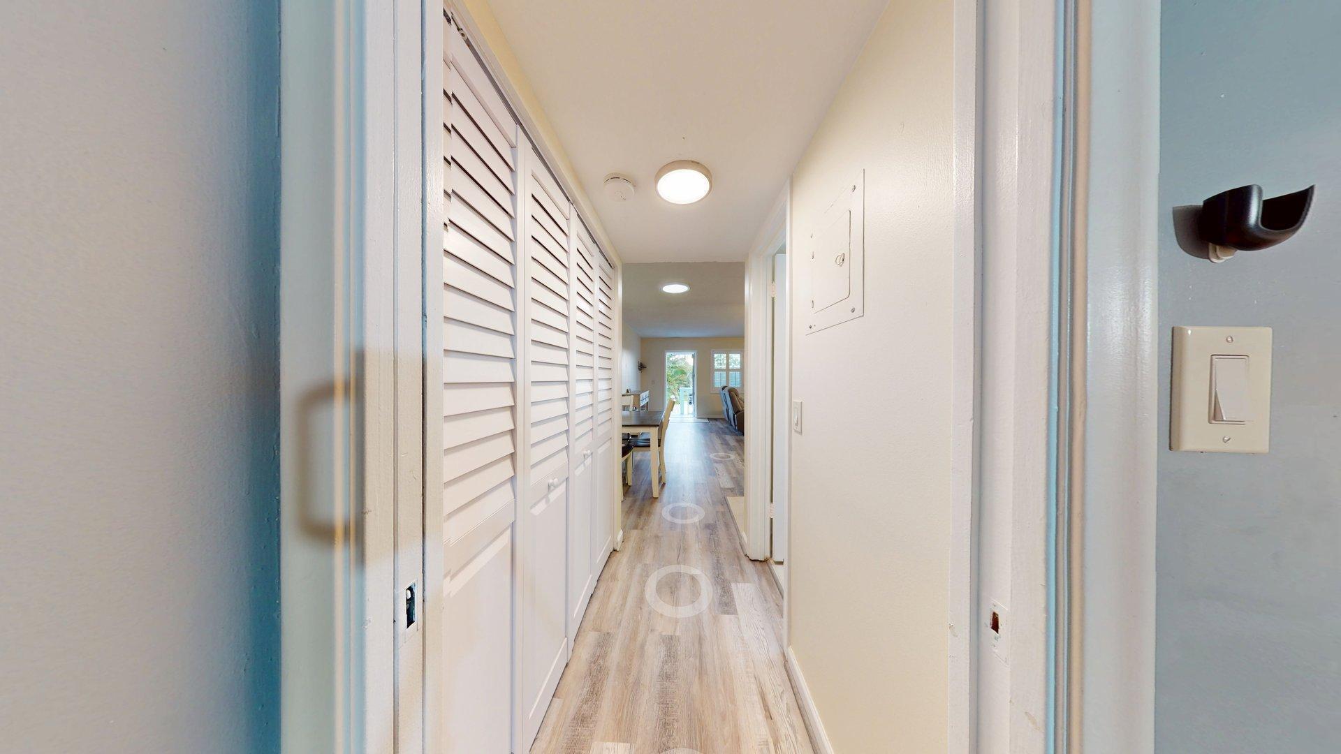 130 Dorchester East, Unit F West Palm Beach, FL 33417 - Photo 20 of 28 a view of a hallway with wooden floor and a bathroom