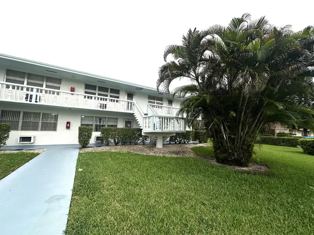 a front view of a house with a yard table and chairs