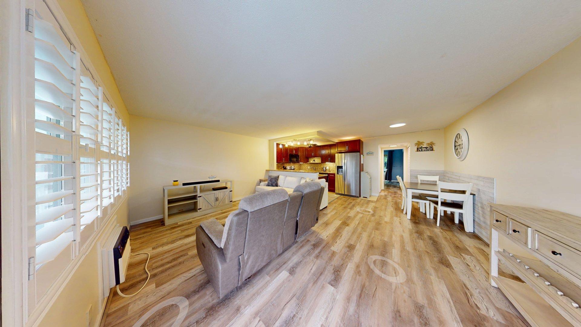 130 Dorchester East, Unit F West Palm Beach, FL 33417 - Photo 6 of 28 a living room with furniture and a flat screen tv