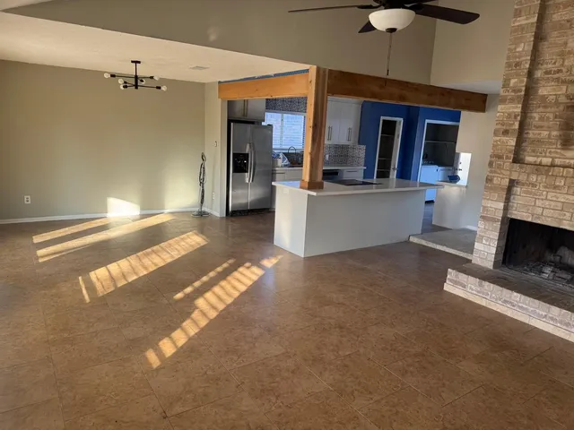 a view of living room with furniture and a fireplace