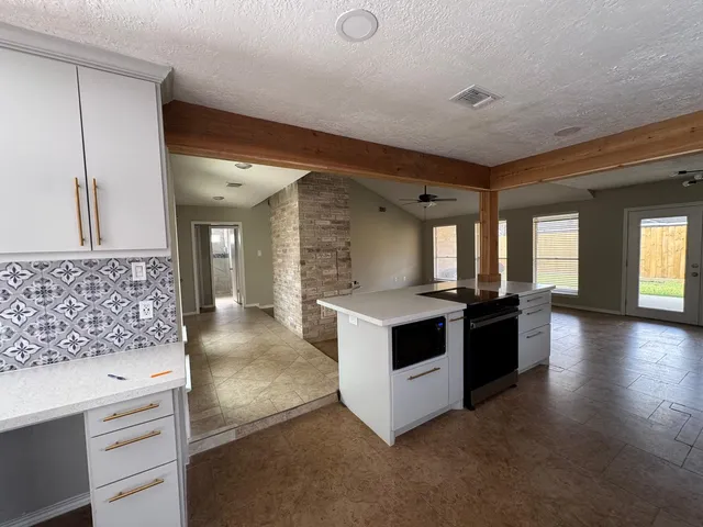 a kitchen with granite countertop a stove and a sink