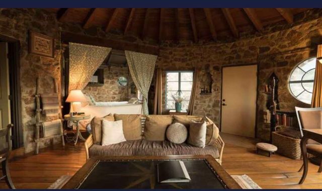 a view of a balcony with furniture and a potted plant