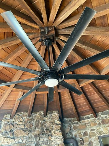 a picture of a room with wooden floor and furniture