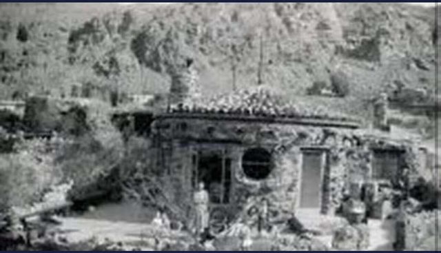 a view of a fireplace with wooden wall