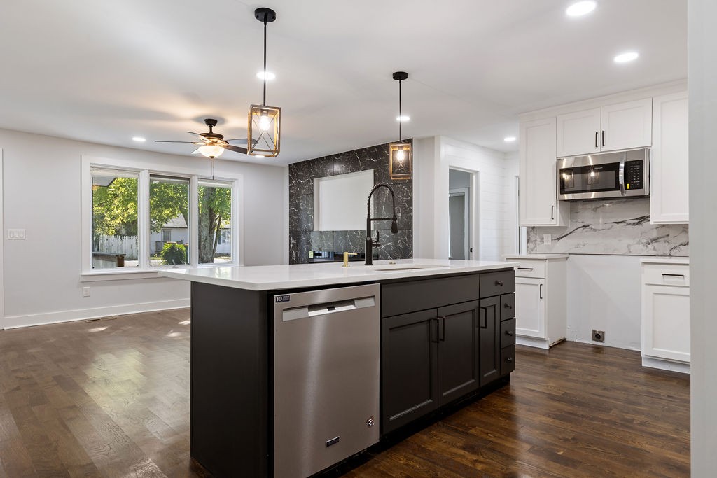 1124 Apple Street Lewisburg, TN 37091 - Photo 11 of 24 a kitchen with kitchen island granite countertop a sink cabinets and wooden floor