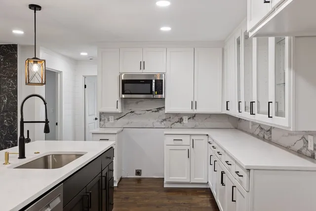 a kitchen with a sink stove and cabinets