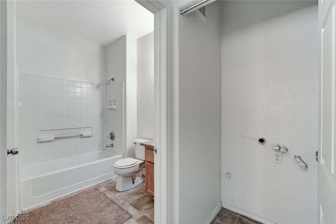 3318 North Decatur Boulevard, Unit 1061 Las Vegas, NV 89130 - Photo 25 of 49 Bathroom featuring bathing tub / shower combination, light tile patterned floors, and vanity