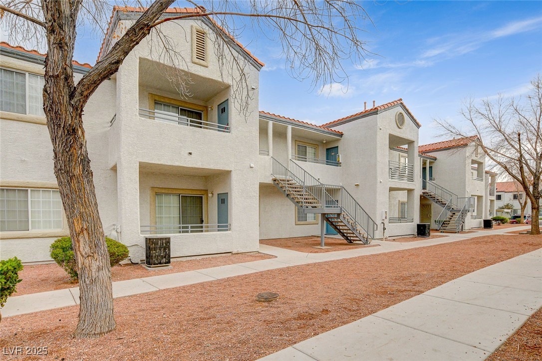 3318 North Decatur Boulevard, Unit 1061 Las Vegas, NV 89130 - Photo 32 of 49 View of building exterior with a residential view and stairs