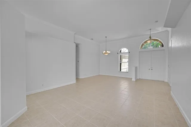an empty room with a kitchen and a sink