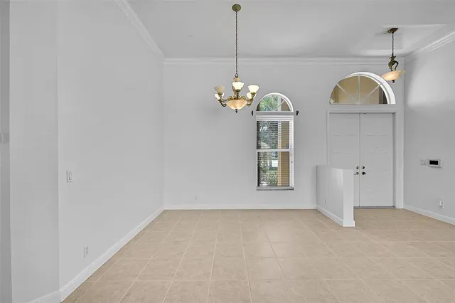 a large white kitchen with a large window