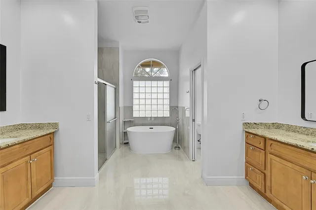 a view of walk in closet with wooden floor