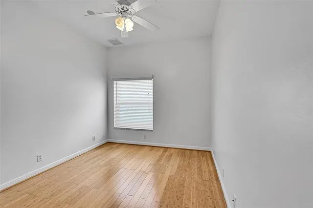 a view of a room with wooden floor and brick walls