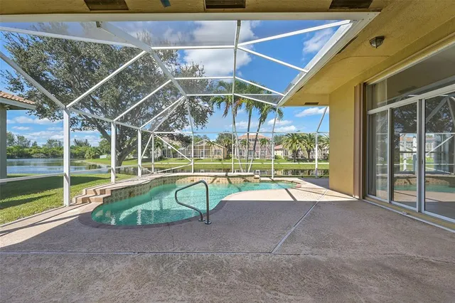 a view of a swimming pool with a garden and trees
