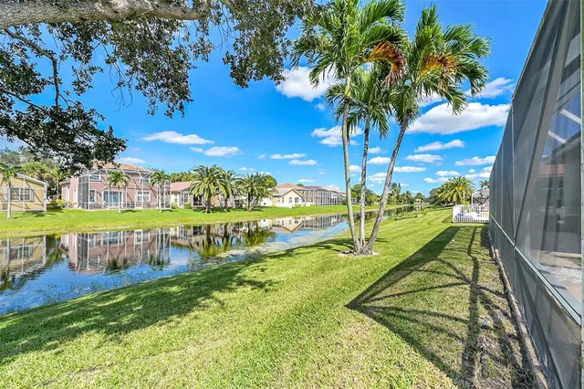 an aerial view of residential houses with outdoor space and swimming pool