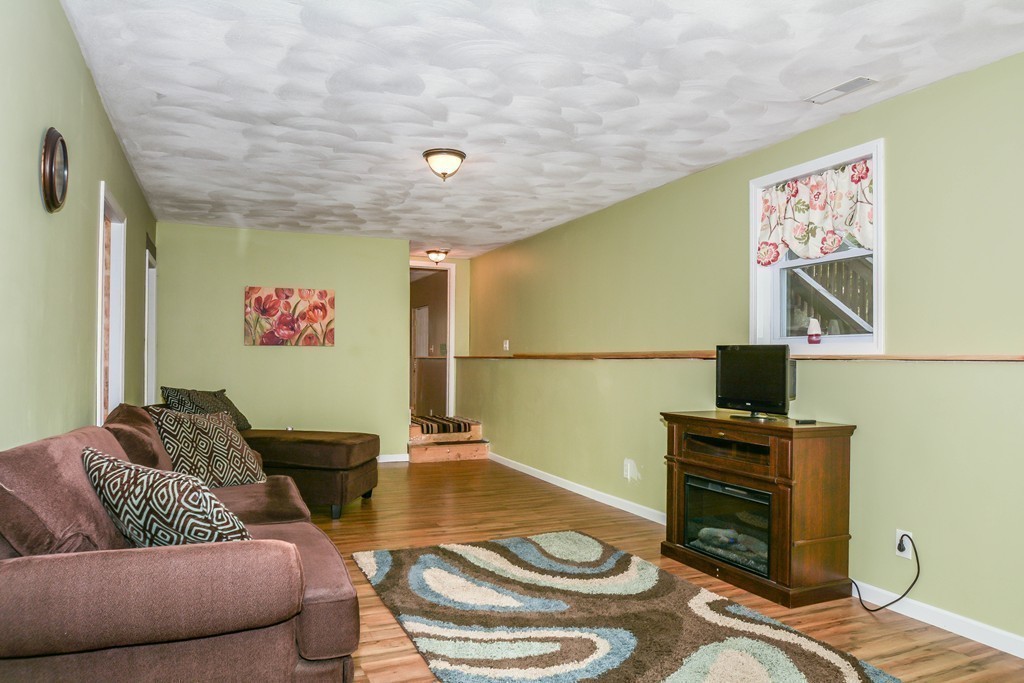 92 Concord Road Billerica, MA 01821 - Photo 20 of 25 a living room with furniture and a flat screen tv