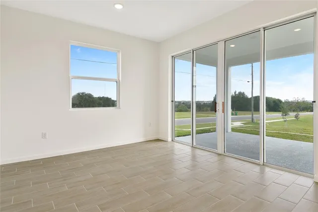 an empty room with sliding glass door and mountain view