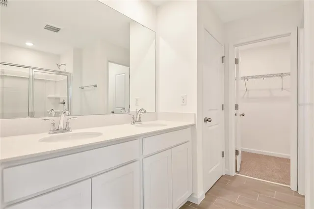 a bathroom with a double vanity sink mirror and double