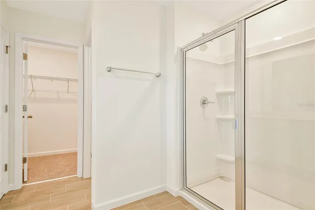 a bathroom with a glass shower door