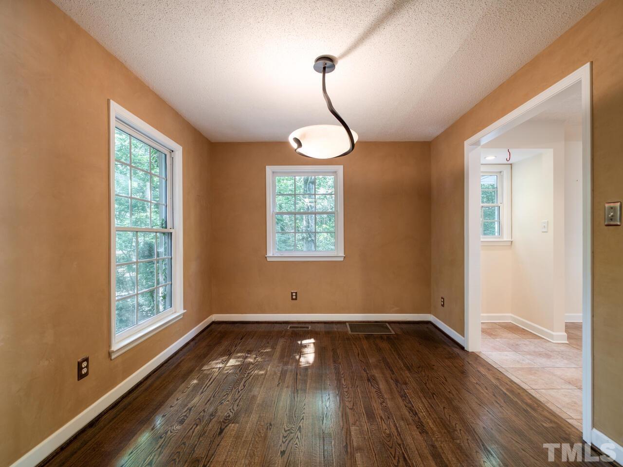 115 Old Oxford Road Chapel Hill, NC 27514 - Photo 21 of 54 an empty room with wooden floor and windows