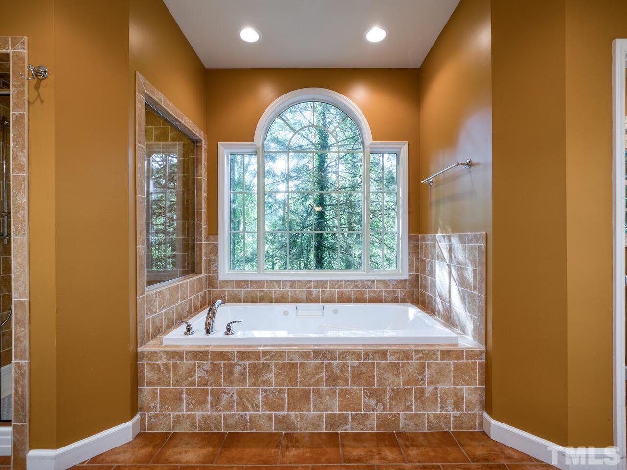 115 Old Oxford Road Chapel Hill, NC 27514 - Photo 27 of 54 a bathroom with a bathtub and window