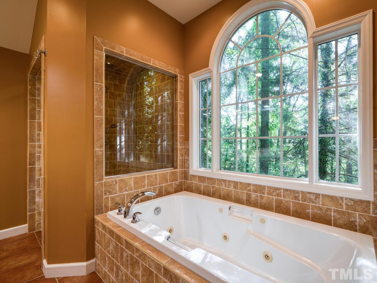 115 Old Oxford Road Chapel Hill, NC 27514 - Photo 28 of 54 a bathroom with a bathtub and windows