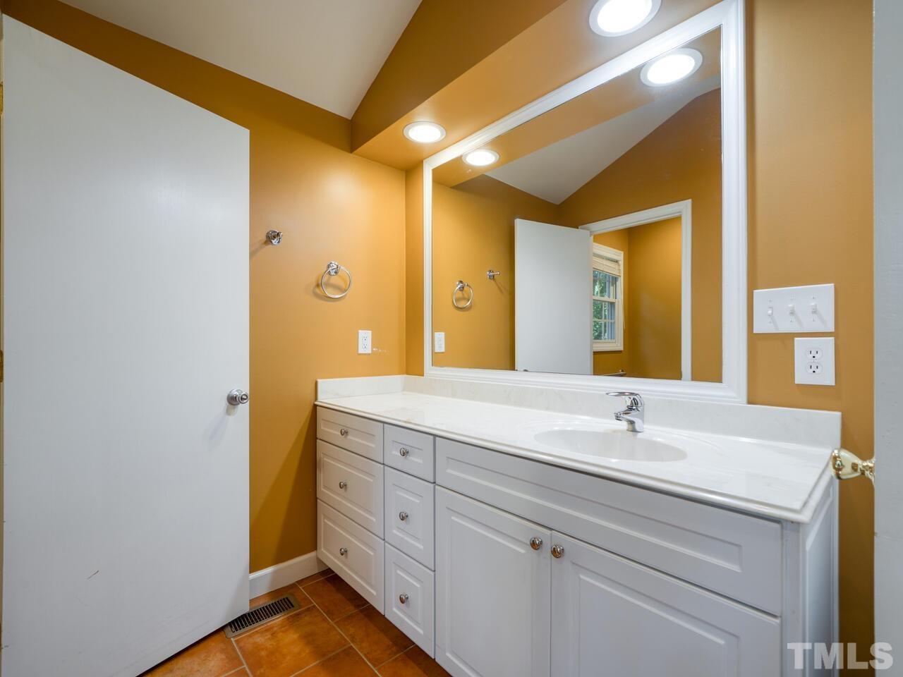 115 Old Oxford Road Chapel Hill, NC 27514 - Photo 29 of 54 a bathroom with a double vanity sink and mirror