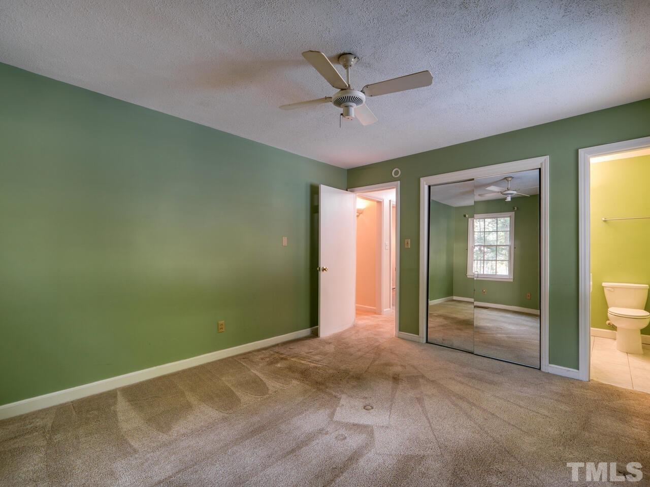 115 Old Oxford Road Chapel Hill, NC 27514 - Photo 31 of 54 an empty room with closet and a ceiling fan