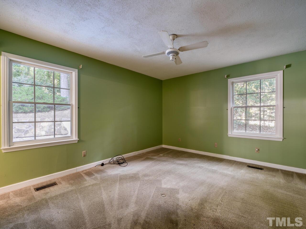 115 Old Oxford Road Chapel Hill, NC 27514 - Photo 32 of 54 an empty room with a window and ceiling fan