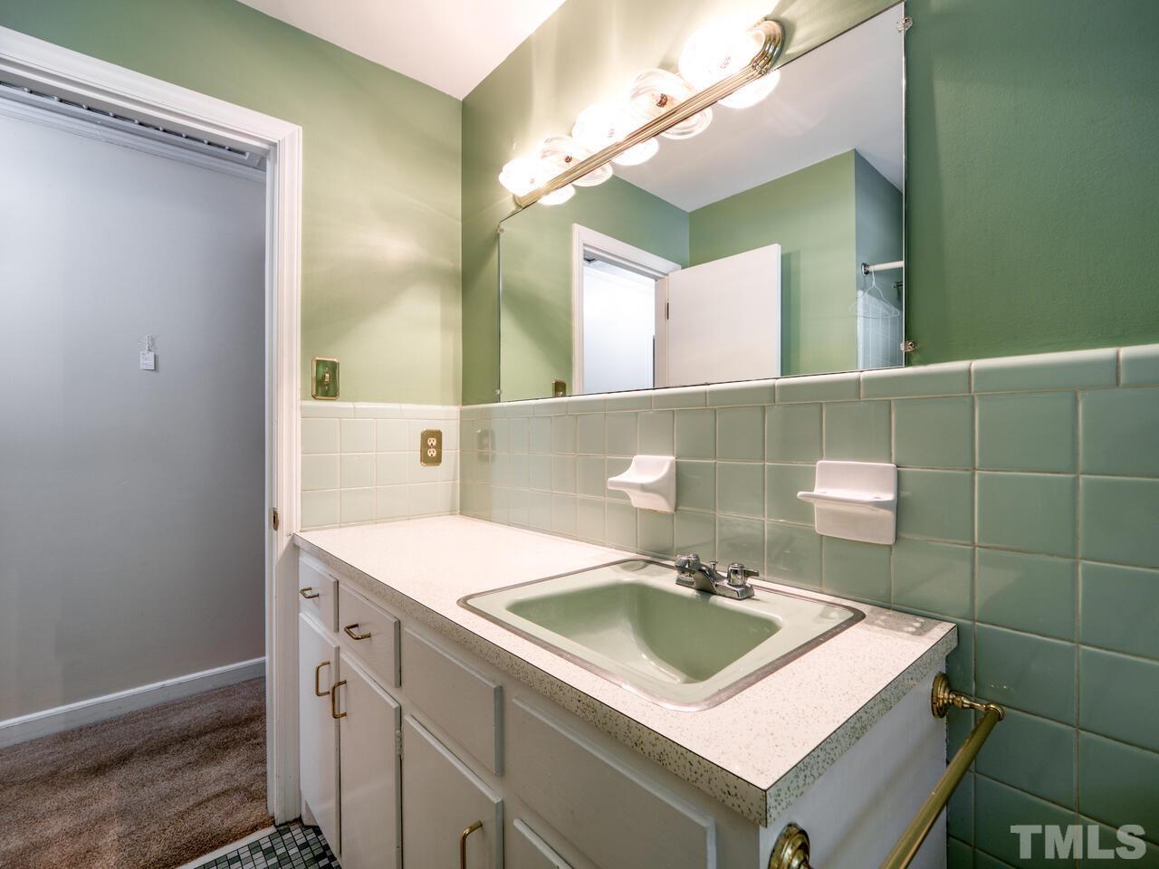 115 Old Oxford Road Chapel Hill, NC 27514 - Photo 39 of 54 a bathroom with a sink vanity and a mirror