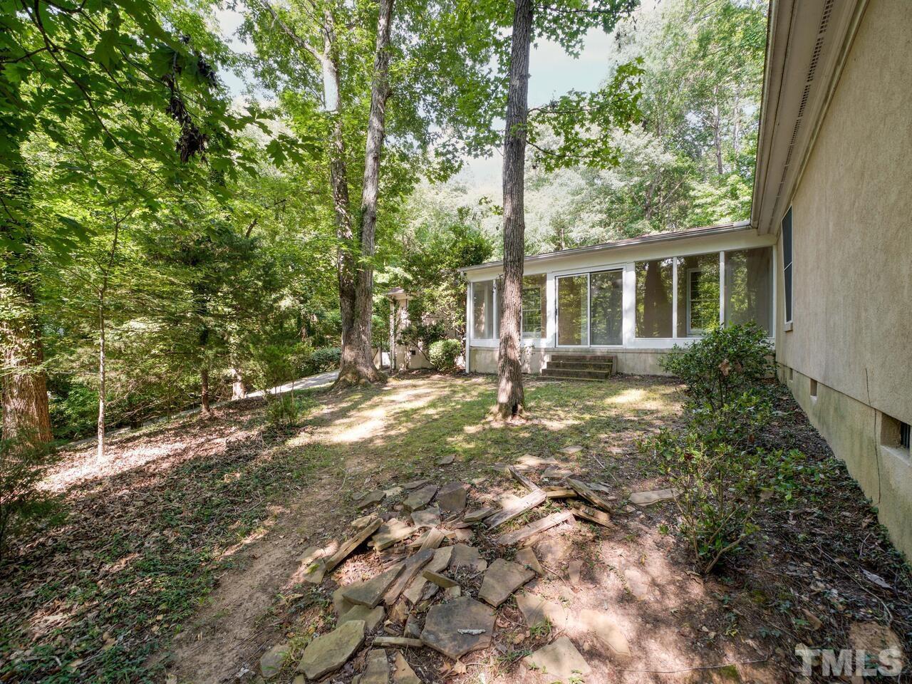 115 Old Oxford Road Chapel Hill, NC 27514 - Photo 44 of 54 a backyard of a house with table and chairs