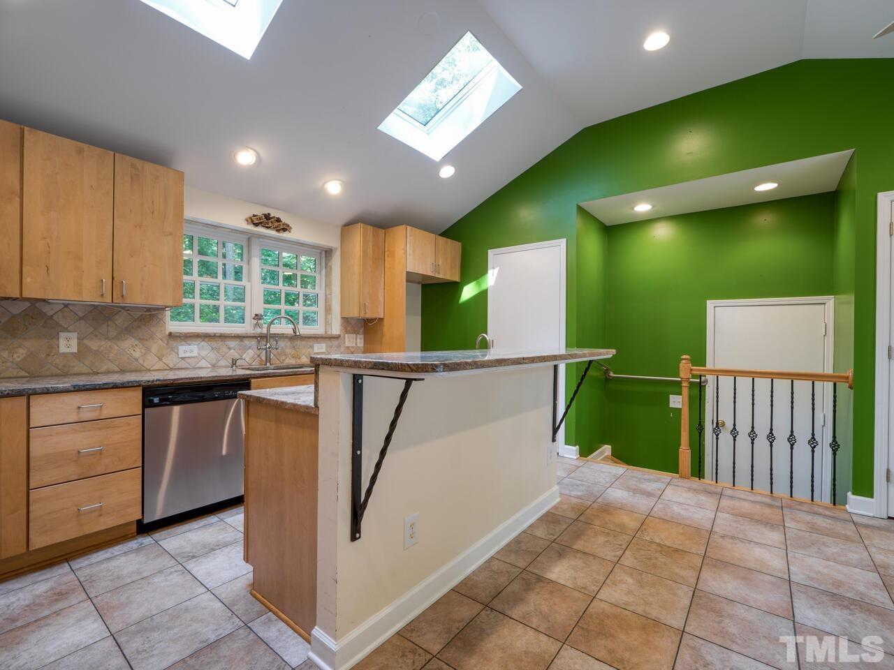 115 Old Oxford Road Chapel Hill, NC 27514 - Photo 5 of 54 a kitchen with lots of counter space cabinets and a chandelier