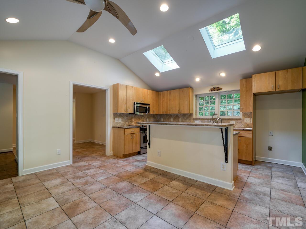 115 Old Oxford Road Chapel Hill, NC 27514 - Photo 6 of 54 a kitchen with granite countertop a refrigerator and a sink