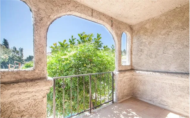 a couple of potted plants in front of door