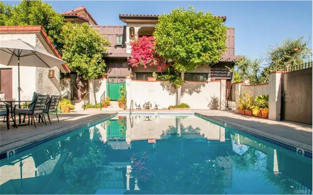 a view of swimming pool with outdoor seating and plants
