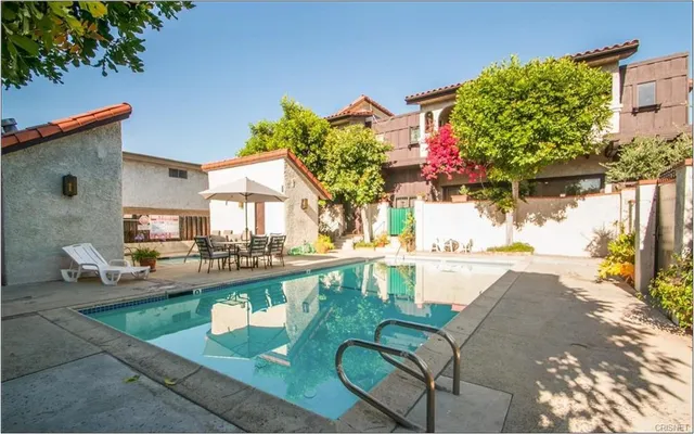 a view of a swimming pool with a patio