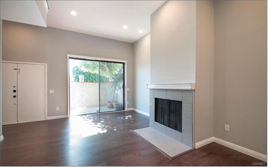 17824 Killion Street Encino, CA 91316 - Photo 4 of 25 a view of a livingroom with wooden floor and a fireplace