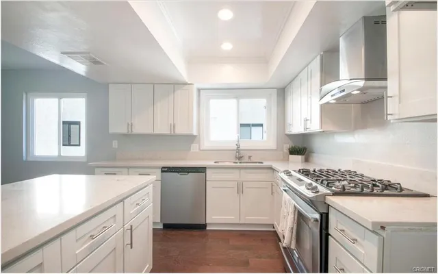 a kitchen with a sink stove top oven and cabinets