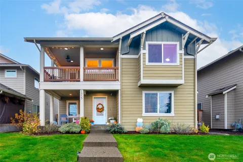 a front view of a house with a yard and fountain