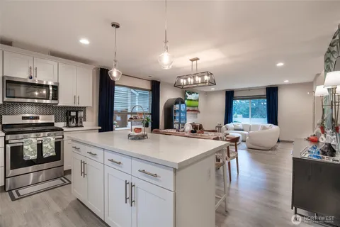 a kitchen with a stove a sink and a refrigerator