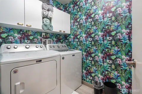a utility room with dryer and flowers