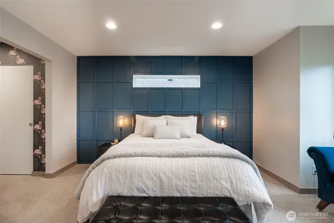 a bedroom with a bed and lamps