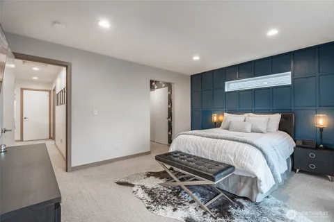 a spacious bedroom with a bed and a couch