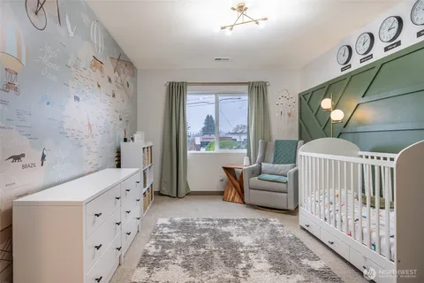 a bedroom with furniture and a large window