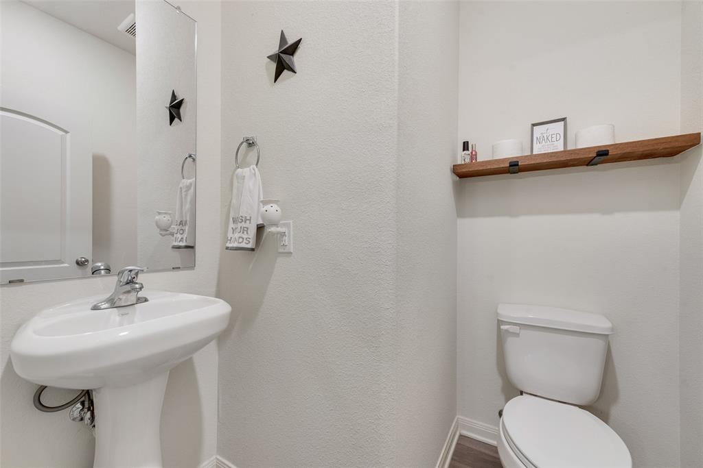 159 Bush Drive Venus, TX 76084 - Photo 12 of 24 a bathroom with a toilet sink and mirror