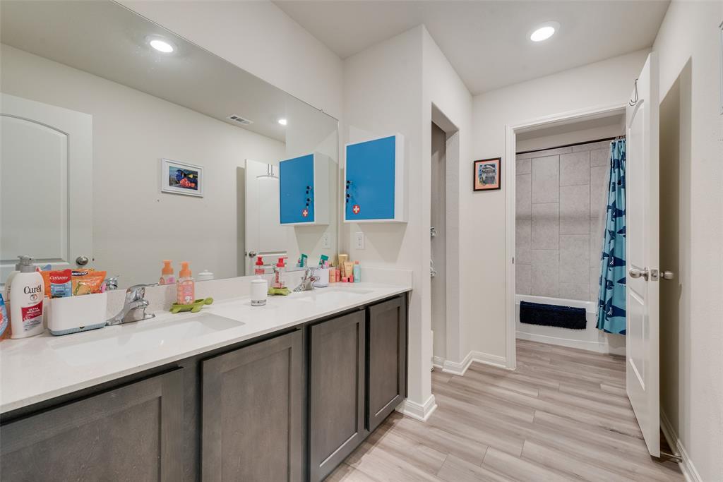 159 Bush Drive Venus, TX 76084 - Photo 17 of 24 a hallway with white cabinets and wooden floor