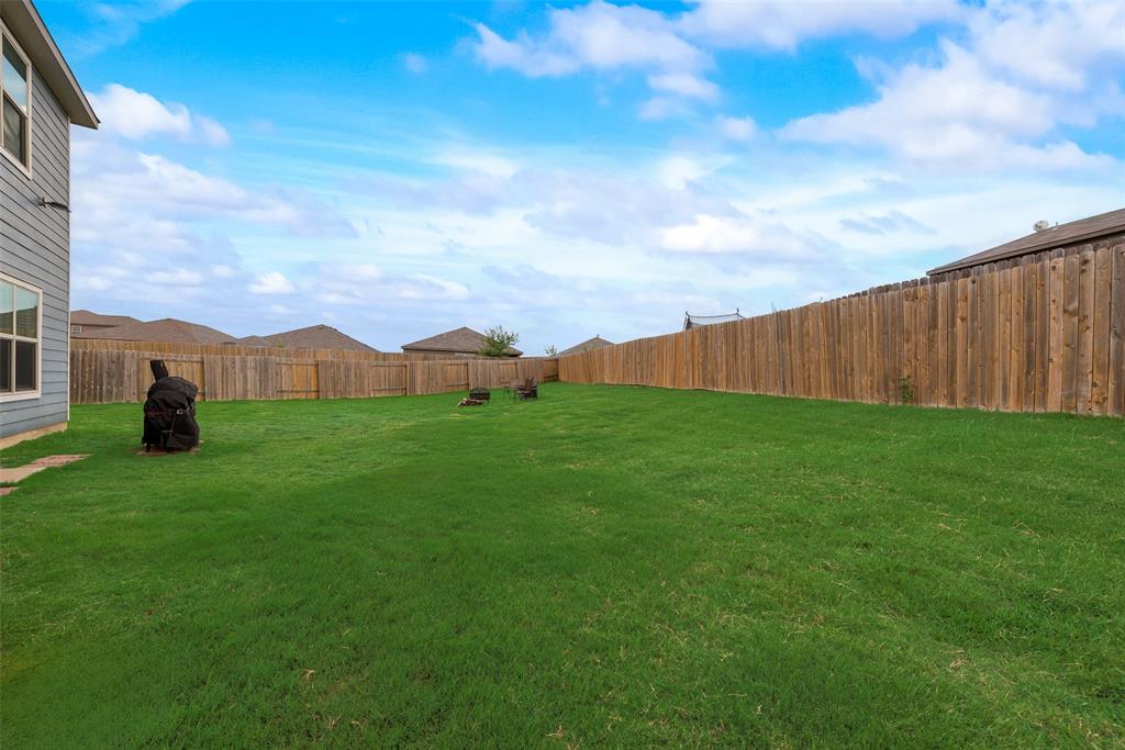 159 Bush Drive Venus, TX 76084 - Photo 21 of 24 a view of a garden with a building in the background